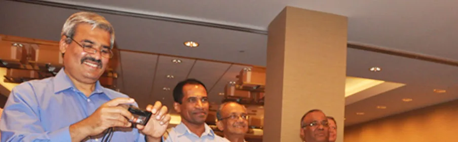 An alumnus photographing friends at a reunion