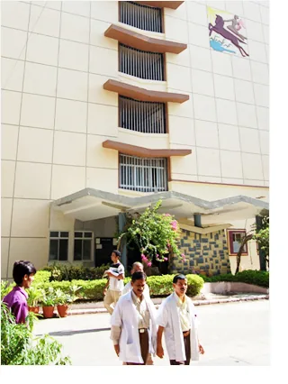 Students walking outside the TNMC college building